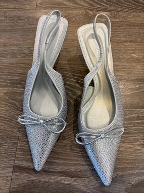 Glamorous Silver Pointed Slingback Heels with Bow Accent